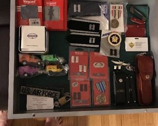 Keshaw  knife set, Swiss army, vanguard military patches and medals, fossil watch, and Kellogg collectible diecast cars.
