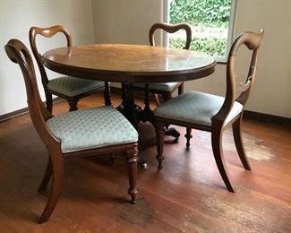 Inlaid wood oval dining table with fancy bottom and 4 chairs
