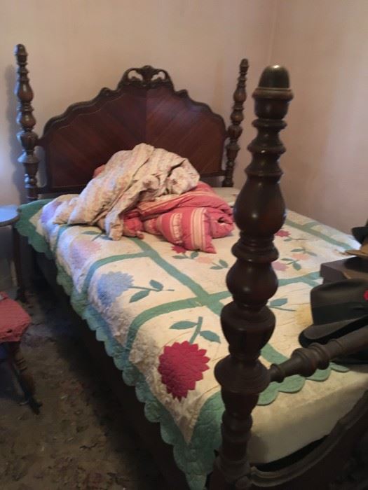 This four-poster bed is in walnut -- note the beautiful quilt.