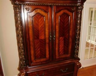 Carved wardrobe. 2 doors over 2 drawers. Ornate. $675