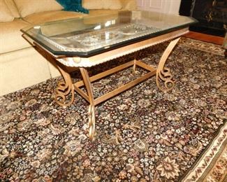 Rug is sold.                                                                                            
 glass top solid brass painted table $225