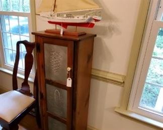 small pie cabinet and display sailboat