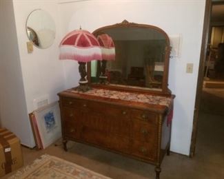 Antique dresser with mirror.  Also antique lamp with fringed shade.