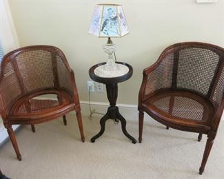2 wooden cane chairs, one seat needs repair, antique 3 leg table w/ marble insert, several kerosene lamps that have been electrified