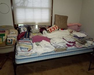 Trundle bed loaded with sheets and linen