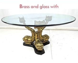Lot 325 Dolphin Base Cocktail Table. Brass and glass with