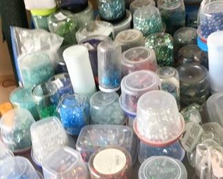Many containers of various size & color beads.