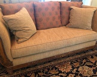 Lovely Lexington upholstered sofa featuring nailhead grommet trim & carved wood detail