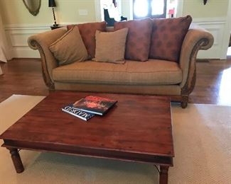 Solid wood coffee table with nail detail and masculine metal accents 