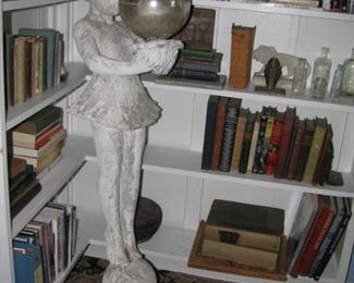 Cement girl holding gazing ball