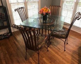 Scrolled Metal & Wood Base 4-Chair Dining Set. Gorgeous bronze colored scrolled metal padded chairs and unique open wood & metal base with 42" square glass top which is squared off at the ends.
