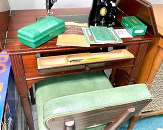 Old singer sewing machine in cabinet
Sewing chair