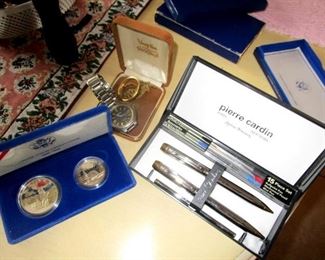 Commemorative silver coins and pens. Some silver jewelry and watches.