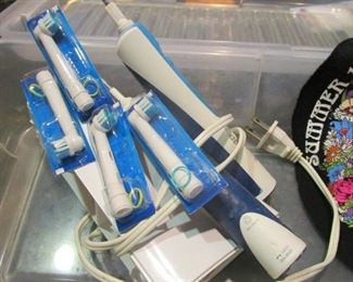 Battery tooth brushes with extra brushes and charger. Look unused.