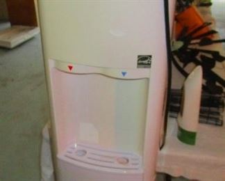 Water cooler. Hot and cold. Holds a five gallon jug.