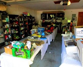 Tables full of useful tools, fittings and items. The cabinets are full of car care products