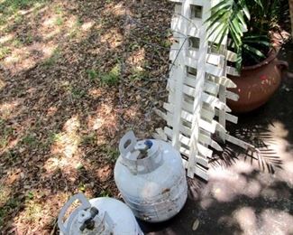 Propane tanks. 1 full and some garden fencing
