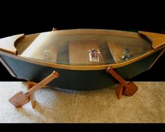 The Canoe  Glass Covered Coffee Table  measures 24" by 58".