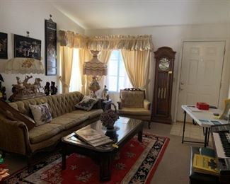 Oriental/vintage living room.  There's a lovely grandfather clock sitting right by the front door! 