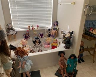 The bathtub is full of cute dolls that need a new home!