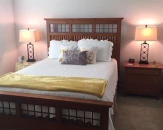Bed and throw pillows - king and queen size.  Ruffled taupe bed skirt (queen).  Two Timex electric alarm clocks with battery backup.  Round table with custom cut glass top and table cloth.