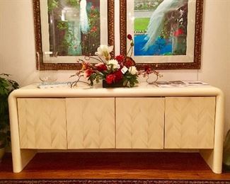 Off-white/cream lacquered waterfall credenza. Four doors, plus two drawers within each  side.