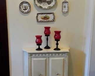 plates, marble top cabinet, candle holders