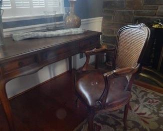 Great arm chair with cane back and leather seating.