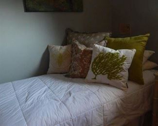 Twin bed in guest room and lots of bedding too!