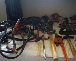 jumper cables, pipe wrench, hammers, clamps, tools