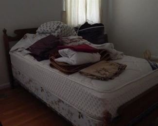 Twin bed with linens, bedding and more.