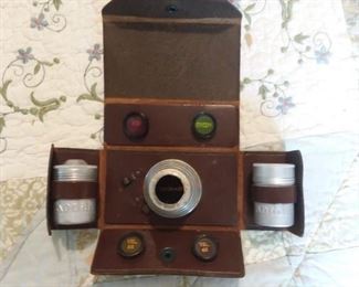 Vintage Brownie camera lens and sunshade case with aluminum film containers