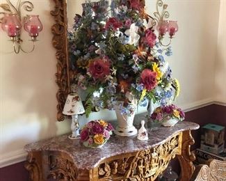 marble top table with ornate wood carved base and matching mirror