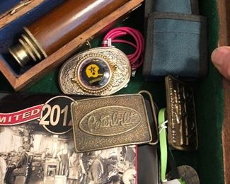 belt buckles, knives and a telescope