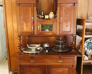 Antique German cabinet and hutch with stained glass middle door. 