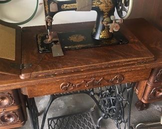 Antique, early 1900's Singer sewing machine. Original manual and some attachments included.