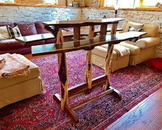 This picture does not capture just how beautifully made this handmade wine table is. The 3 top pieces are cut from the same piece of wood and legs are made from trees branches