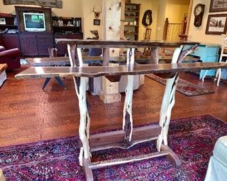 This picture does not capture just how beautifully made this handmade wine table is. The 3 top pieces are cut from the same piece of wood and legs are made from trees branches