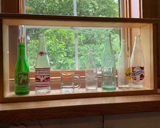 Vintage beverages bottles in framed wooden box