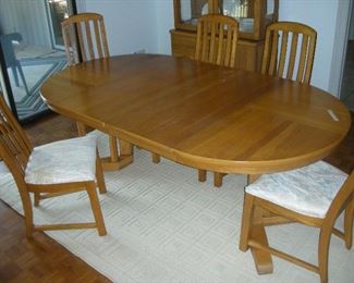 Dining table, 44" round plus two leaves, 80" extended. Six chairs, one with arms.