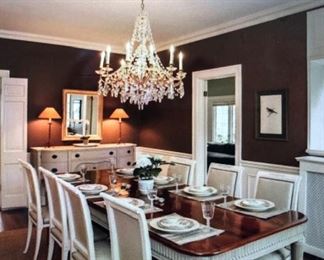 Flamed mahogany thick table top with hand carved, brass capped legged DR table. 8 hand made cream leather upholstered vintage chairs. Mahogany painted buffet/server. 