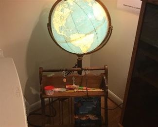 Lite up world globe on stand in front of a nice bookstand!
