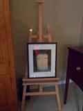 A six foot wooden easel; original framed photograph by photographer/client.
