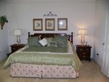 Mahogany King Size Bed with Mattress; 2 matching night stands; pair Brass Lamps.