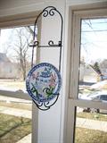 three plate holders and painted dishes