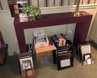 Purple laminate small sofa table and tons of picture frames