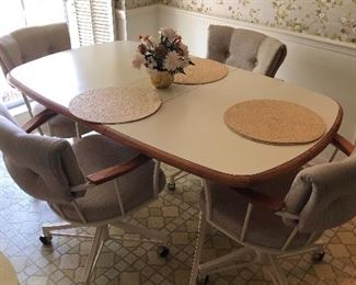 Kitchen table with leaf, four rolling swivel chairs