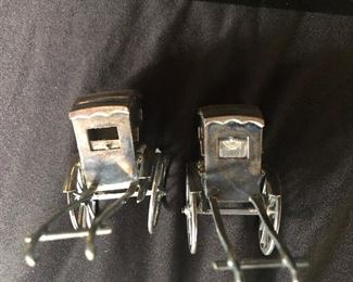 Sterling silver 950 Asian rickshaws.  Pair of WWII salt and pepper shakers.  Rolling wheels, window raises and lowers to load.  Fine engraved detail.  Awesome!