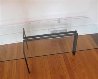 Interesting iron and glass coffee table.