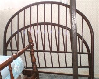 Curved iron spindle antique full size bed with side rails.